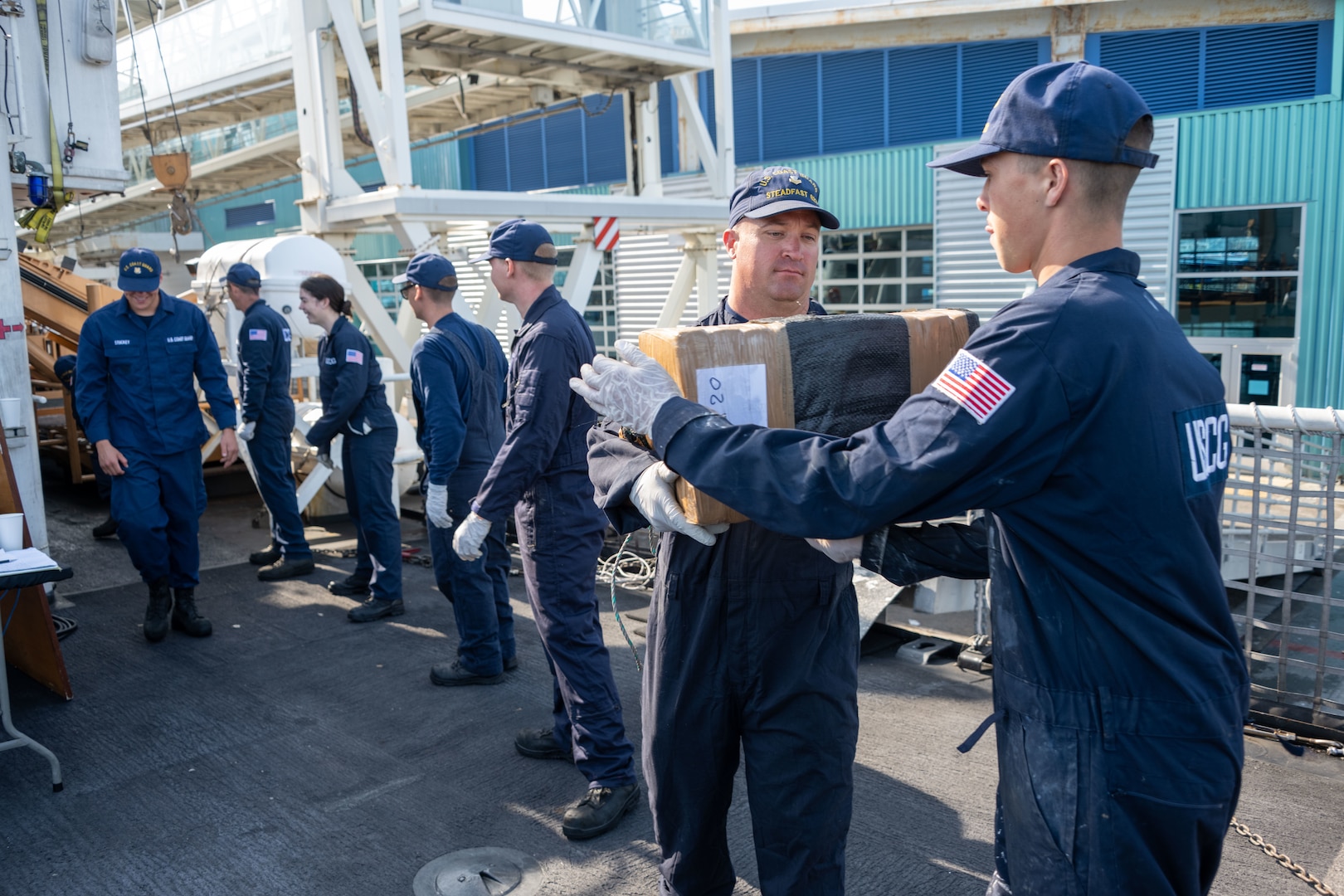 Coast Guard members stack illegal, interdicted drugs on the deck of the cutter in San Diego.