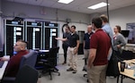 Dr. Christian Schegan demonstrates capabilities of the Machinery Research & Silencing Division Flex Labs’ Real-Time Simulation (RTS) and Hardware-in-the-loop (HIL) capability that is being used to support the Office of Naval Research (ONR) Robust Combat Power Controls (RCPC) Future Naval Capability (FNC) during the Naval Surface Warfare Center, Philadelphia Division (NSWCPD) Machinery Research & Silencing Division Technical Meet and Greet on June 7, 2023. (U.S. Navy photo by Margaret A. Kenyon/Released)