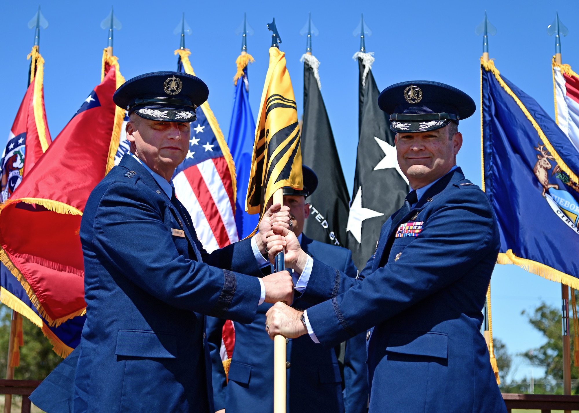 U.S. Space Force Lt. Gen. Michael Guetlein, Space Systems Command commander, passes the Space Launch Delta 30 flag to U.S. Space Force Col. Mark Shoemaker during the SLD 30 change of command ceremony on Vandenberg Space Force Base, Calif., July 13, 2023. U.S. Space Force Col. Robert Long relinquished command to Shoemaker. (U.S. Space Force photo by Airman 1st Class Ryan Quijas)