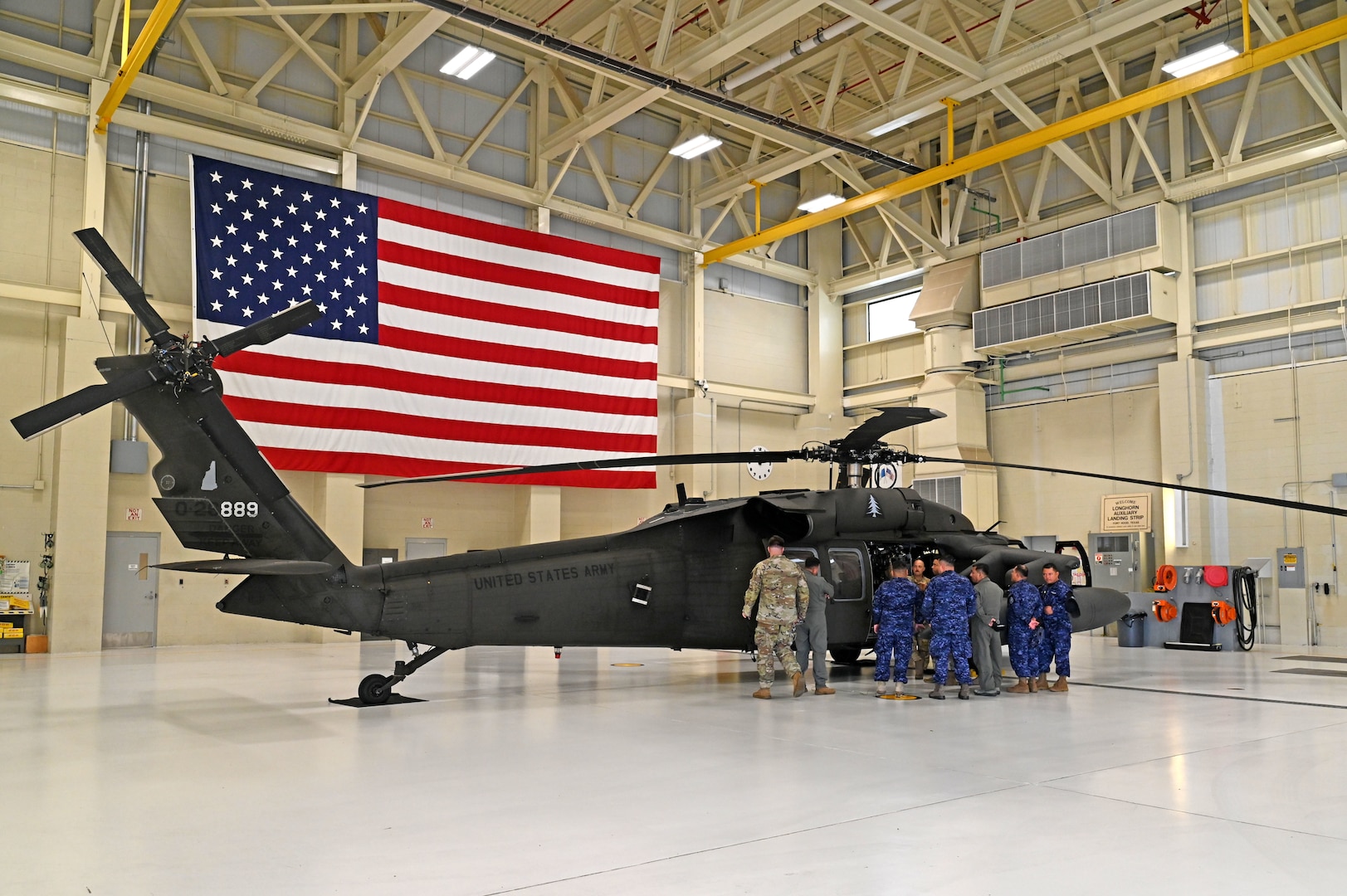 Seven military guests from El Salvador exchange ideas on Black Hawk hoist operation and rescue techniques with NHARNG aviators at the Army Aviation Support Facility on July 11, 2023, in Concord.