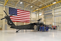 Seven military guests from El Salvador exchange ideas on Black Hawk hoist operation and rescue techniques with NHARNG aviators at the Army Aviation Support Facility on July 11, 2023, in Concord.