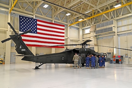 Seven military guests from El Salvador exchange ideas on Black Hawk hoist operation and rescue techniques with NHARNG aviators at the Army Aviation Support Facility on July 11, 2023, in Concord.