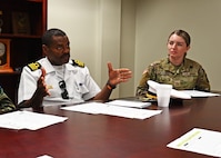 From left, Lt. Col. Domingos Correia, national director of defense for Cabo Verde, and Pfc. Stefane Godoes de Souza, an interpreter with the 197th Field Artillery Brigade, meet with NHARNG aviators during a state partnership exchange July 11, 2023, at the Army Aviation Support Facility in Concord, New Hampshire.