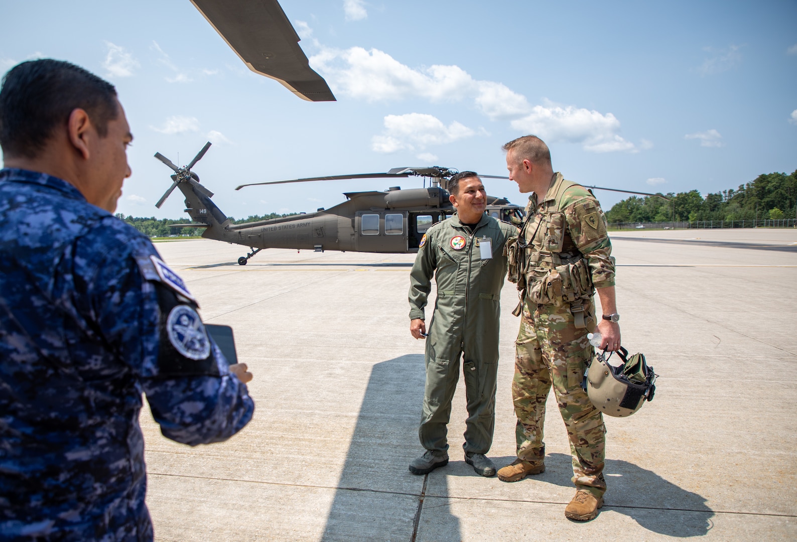 From left, Col. Saúl Orantes, commander of First Air Brigade, Salvadoran Air Force, poses for a photo with Chief Warrant Officer 3 Luke Koladish, a pilot with Charlie Company, 3rd Battalion, 238th Aviation Regiment (MEDEVAC), prior to boarding their flight July 11, 2023, at the Army Aviation Support Facility in Concord, New Hampshire.