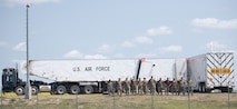 Airmen from the 91st Missile Maintenance Squadron pose for a group photo at a missile site at Minot Air Force Base, July 10, 2023. These Airmen helped load a Minuteman III intercontinental ballistic missile in just 18 hours for Operation Bullystick. Operation Bullystick was held to test agile combat employment concepts. (U.S. Air Force photos by Airman 1st Class Trust Tate)
