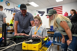 A student demonstrates a project for his family.
