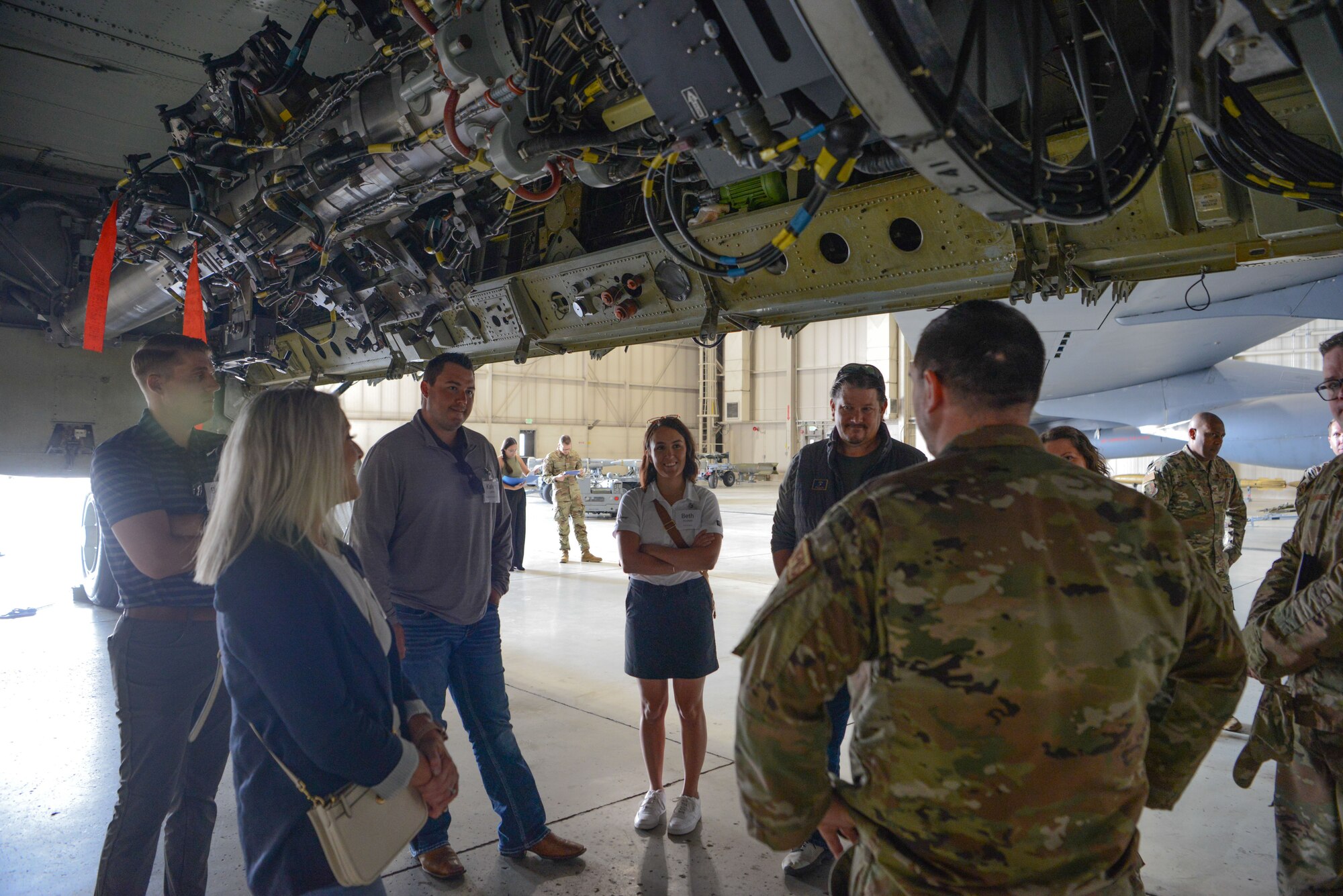 Civilian leaders of Minot tour the underbelly of a B-52H Stratofortress at Minot Air Force Base, North Dakota, July 13, 2023. The B-52H has been assigned to Minot Air Force Base since 1968 and plays a critical role in the 5th Bomb Wing mission with its ability to perform strategic attack, air interdiction, offensive counter-air and maritime operations. (U.S. Air Force photo by Airman 1st Class Trust Tate)