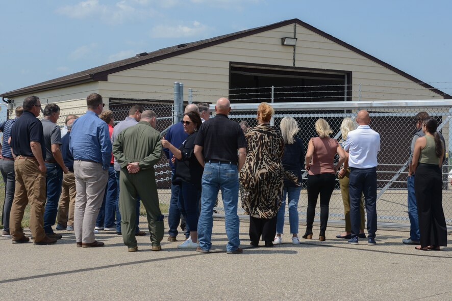 Civic Leaders wait behind the fence of a Missile Alert Facility, Minot Air Force Base, North Dakota, July 13, 2023. MAFs are the link to the launch control centers connected via computer to intercontinental ballistic missiles. (U.S. Air Force photo by Airman 1st Class Trust Tate)