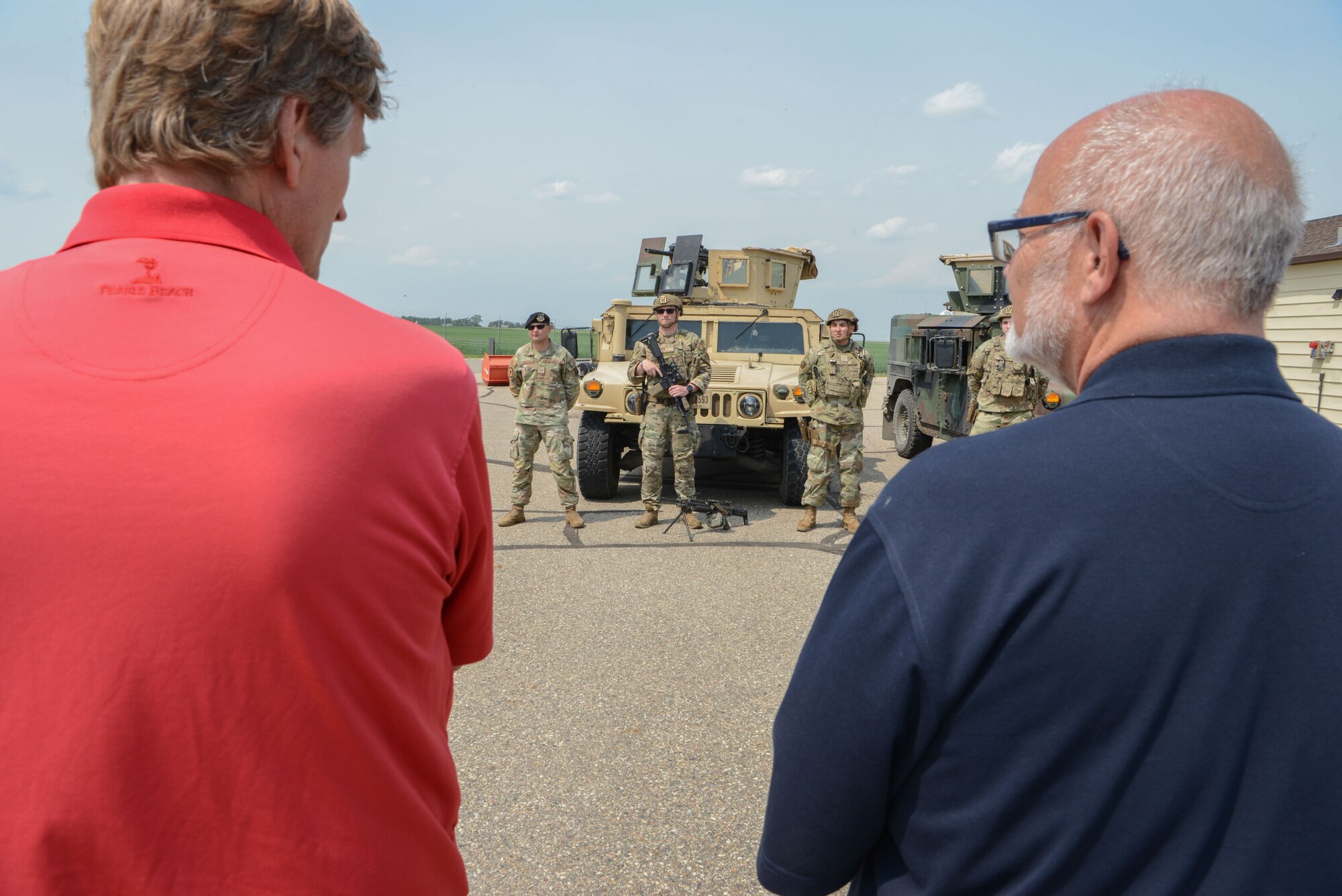 Airmen from the 91st Security Forces Group speak with Minot civic leaders of the Minot community outside of a Missile Alert Facility at Minot Air Force Base, North Dakota, July 13, 2023. The civilian leader tour was meant to build morale and camaraderie between the military and the civilian community. (U.S. Air Force photo by Airman 1st Class Trust Tate)