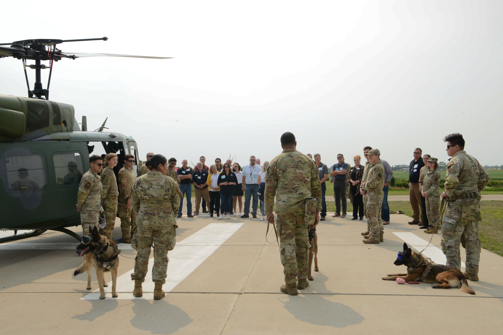 Minot civic leaders speak to 91st Security Forces Squadron Military Working Dog Handlers at Minot Air Force Base, North Dakota, July 13, 2023. The civilian leaders were briefed on how the dogs are trained for helicopter operations and safety assurance. (U.S Air Force photo by Airman 1st Class Trust Tate)