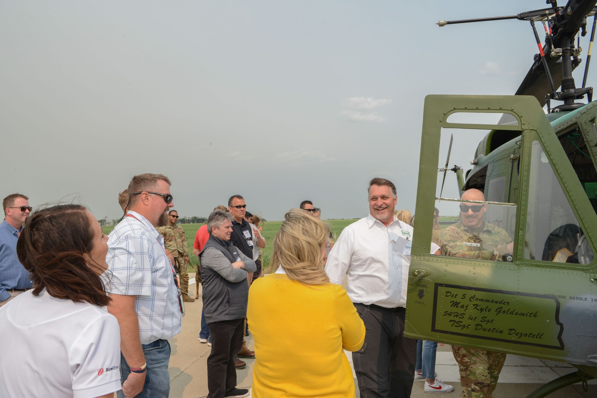 Civic leaders of the Minot community observe the UH-1N Iroquois Helicopter at Minot Air Force Base, North Dakota, July 13, 2023. Civilian leader tours are intended to teach community members about the mission at Minot Air Force Base and emphasize the importance of the roles played by the public in the lives of Minot Airmen. (U.S. Air Force photo by Airman 1st Class Trust Tate)