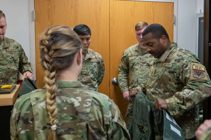 U.S. Air Force Master Sgt. Marques Bones, 9th Force Support Squadron development advisor, explains the gear used by the T-38 pilots during their flights July 14, 2023, at Beale Air Force Base, California.