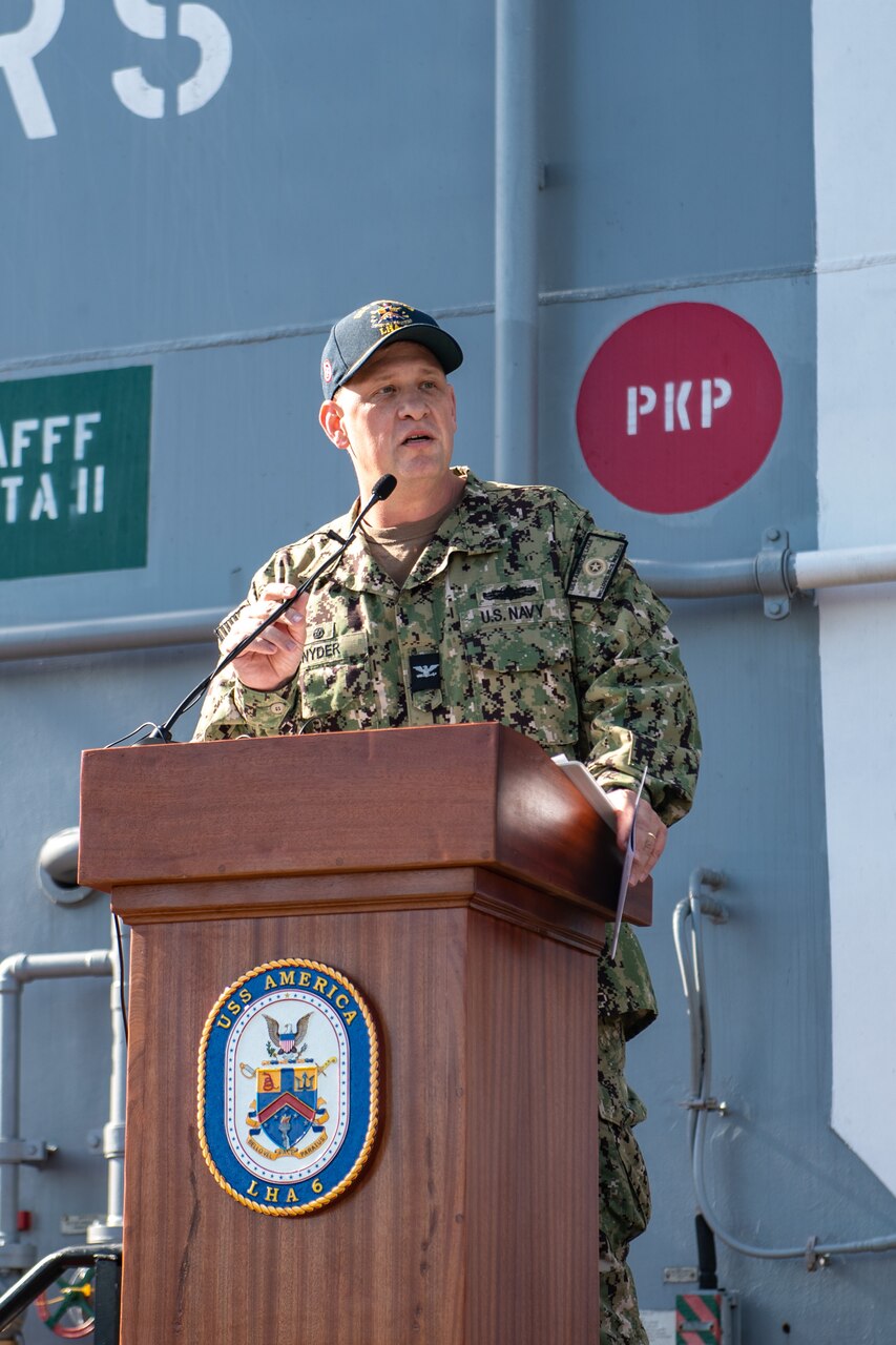 Capt. Shockey Snyder, commanding officer of the forward-deployed amphibious assault carrier USS America (LHA 6), reads his orders at a change of command ceremony on the ship’s flight deck during a scheduled port visit to Brisbane, Australia, July 14, 2023. America, lead ship of the America Amphibious Ready Group, is operating in the U.S. 7th Fleet area of operations. U.S. 7th Fleet is the U.S. Navy’s largest forward-deployed numbered fleet, and routinely interacts and operates with allies and partners in preserving a free and open Indo-Pacific region.