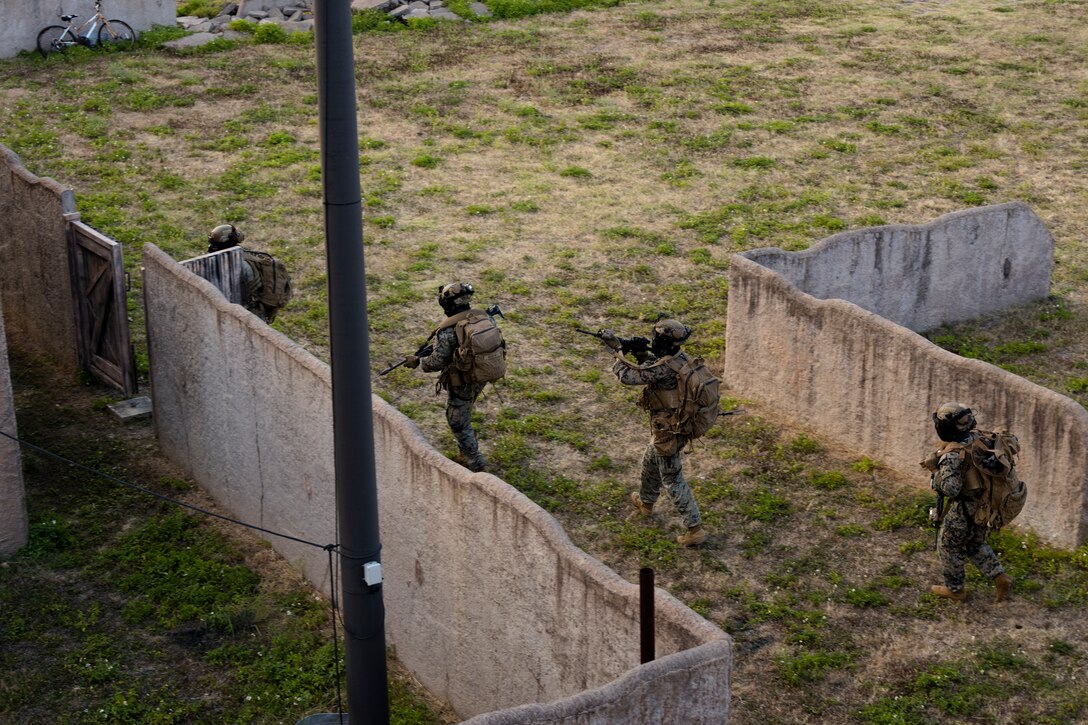 U.S. Marines with Advanced Infantry Training Battalion, School of Infantry-West, Hawaii Detachment, advance towards a building during urban operations training, Marine Corps Training Area Bellows, July 11, 2023. The training was conducted as part of the Advanced Infantry Marine Course. AIMC is designed to enhance and test Marines’ skills with a focus on reinforcing proper patrols and operational procedures. (U.S. Marine Corps photo by Cpl. Chandler Stacy)