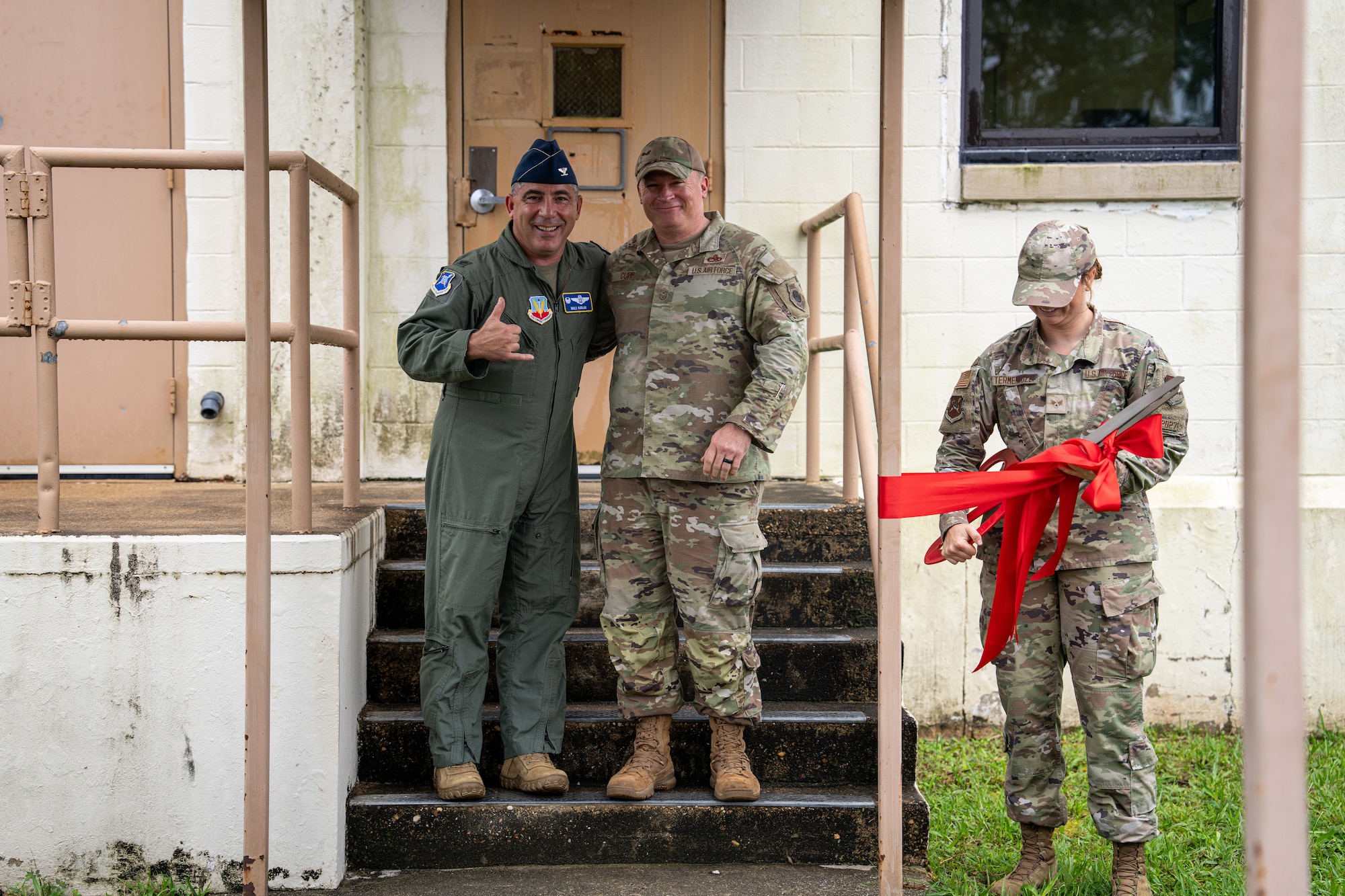 U.S. Air Force Col. Josh Koslov, 350th Spectrum Warfare Wing commander, left, Chief Master Sgt. William Cupp, 350th SWW command chief, center, and Senior Airman Robbi Termentozzi, Program Management Office programs manager, right, celebrate a ribbon cutting ceremony for new office spaces at Eglin Air Force Base, July 14, 2023. The new space features 2,300 square feet of workspace including 40 additional workstations. (Courtesy Photo)
