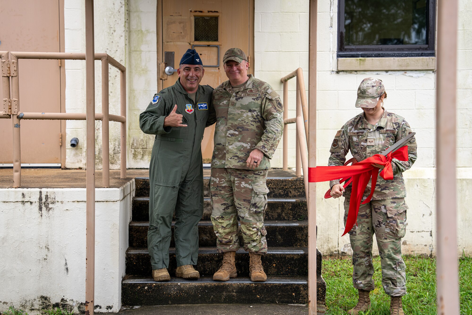 U.S. Air Force Col. Josh Koslov, 350th Spectrum Warfare Wing commander, left, Chief Master Sgt. William Cupp, 350th SWW command chief, center, and Senior Airman Robbi Termentozzi, Program Management Office programs manager, right, celebrate a ribbon cutting ceremony for new office spaces at Eglin Air Force Base, July 14, 2023. The new space features 2,300 square feet of workspace including 40 additional workstations. (Courtesy Photo)