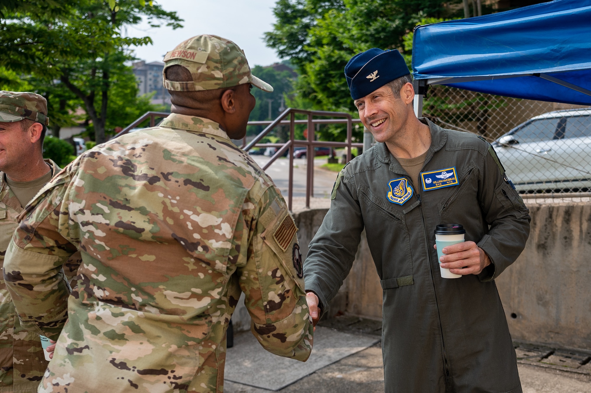 U.S. Air Force Col. William McKibban, right, 51st Fighter Wing commander, shakes hands with Lt. Col. Michael Newson, 51st Communication Squadron, during an immersion tour at Osan Air Base, Republic of Korea, July 10, 2023. These tours allow new command teams to engage directly with the Airmen at the squadron level, building essential bonds of trust and camaraderie, while also gaining a profound appreciation for the invaluable contributions made by their personnel to the overall mission success. (U.S. Air Force photo by Senior Airman Thomas Sjoberg)