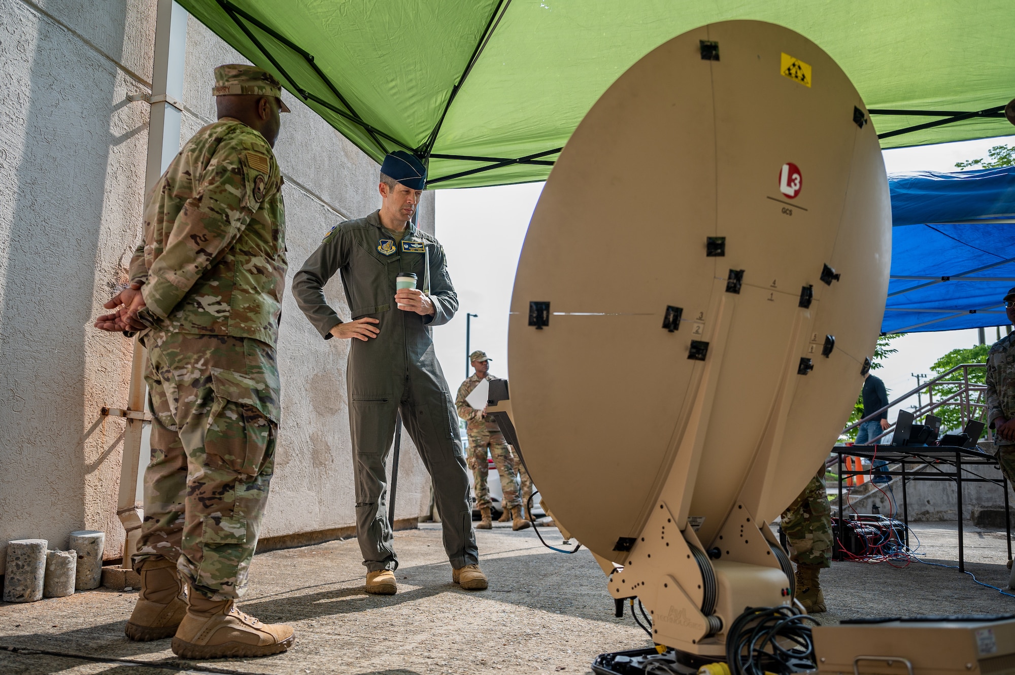 U.S. Air Force Col. William McKibban, right, 51st Fighter Wing commander, examines a Hawkeye Antenna Terminal set up by members of the 51st Communications Squadron at Osan Air Base, Republic of Korea, July 10, 2023. Immersion tours with squadrons are crucial for new commanders as they provide firsthand insights into the operational prowess and challenges faced by their frontline units, fostering a deeper understanding of the Wing's capabilities and mission readiness. (U.S. Air Force photo by Senior Airman Thomas Sjoberg)