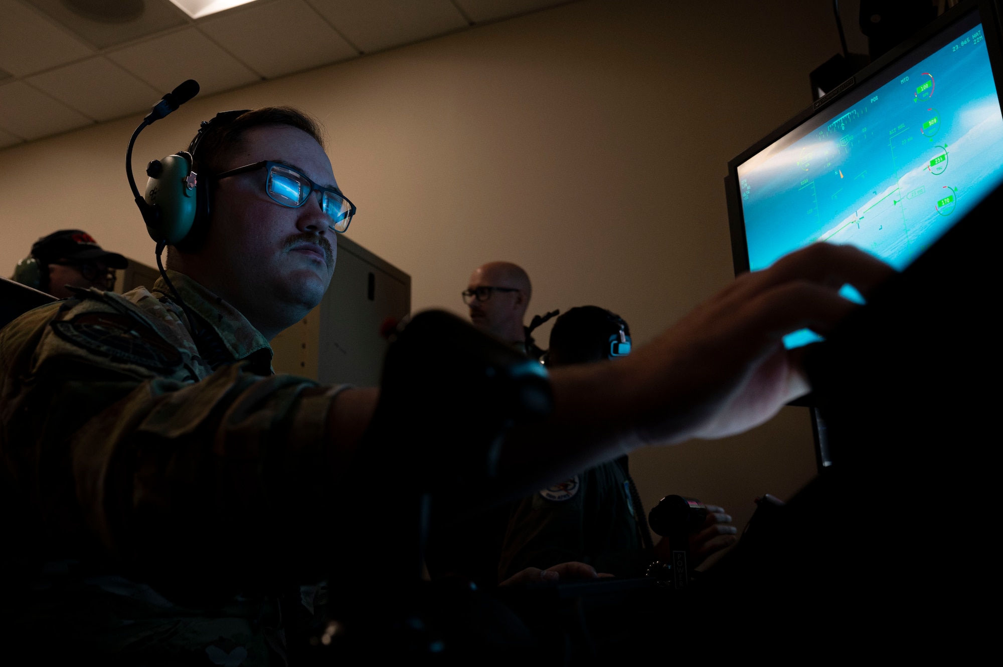 U.S. Air Force Staff Sgt. Jacob Barner, 491st Attack Squadron MQ-9 Reaper sensor operator technician, prepares to take control of a MQ-9 camera at Hancock Field Air National Guard Base, New York, June 22, 2023. The 491st ATKS is composed of both active duty and Air National Guard personnel responsible for training student pilots and sensor operators on how to fly an MQ-9 Reaper. (U.S. Air Force photo by Airman 1st Class Isaiah Pedrazzini)