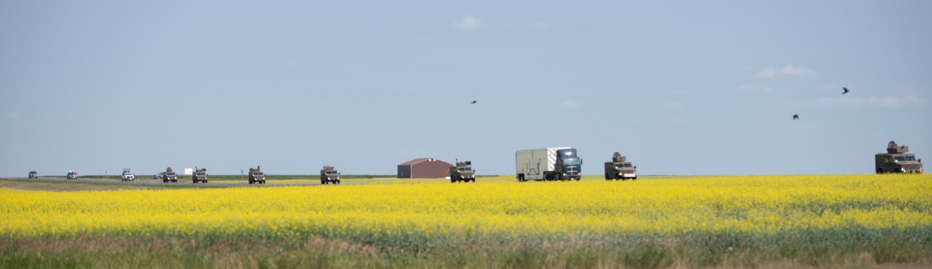 Airmen from the 91st Missile Security Forces Squadron, and the 219th Security Forces Squadron drive in a convoy to a missile silo at Minot Air Force Base, July 10, 2023. The convoy was used to protect the assets being delivered for Operation Bullystick. Operation Bullystick was an event held to test agile combat employment concepts using a Minuteman III intercontinental ballistic missile.  (U.S. Air Force photos by Airman 1st Class Trust Tate)