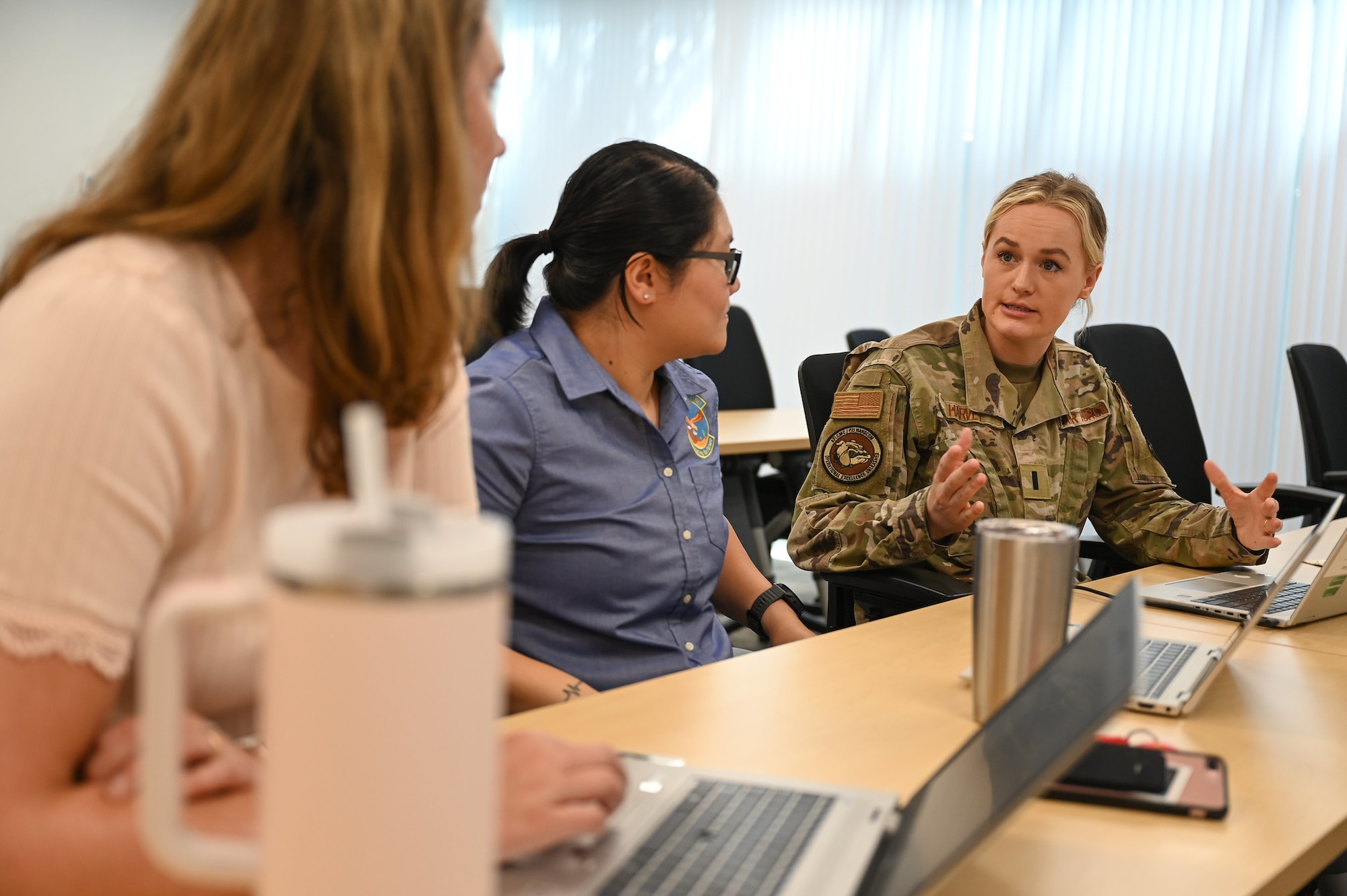 Three women talk during Bootcamp.