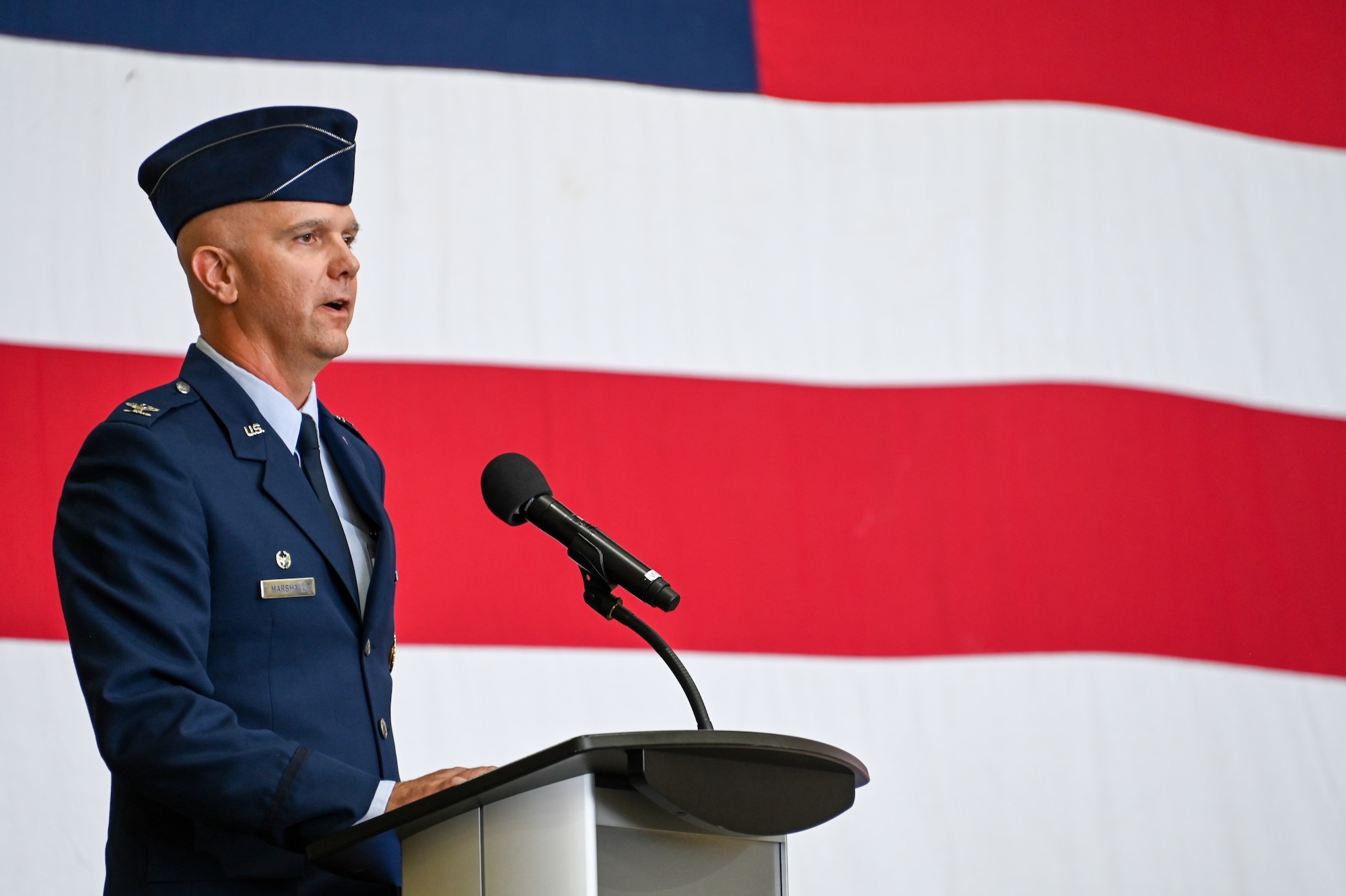 U.S. Air Force Col. Jeffrey Marshall, 97th Air Mobility Wing commander, addresses Airmen for the first time as wing commander at Altus Air Force Base, Oklahoma, July14, 2023. Col. Jeffrey Marshall assumed command of the 97th Air Mobility Wing during the ceremony. (U.S. Air Force photo by Senior Airman Kayla Christenson)