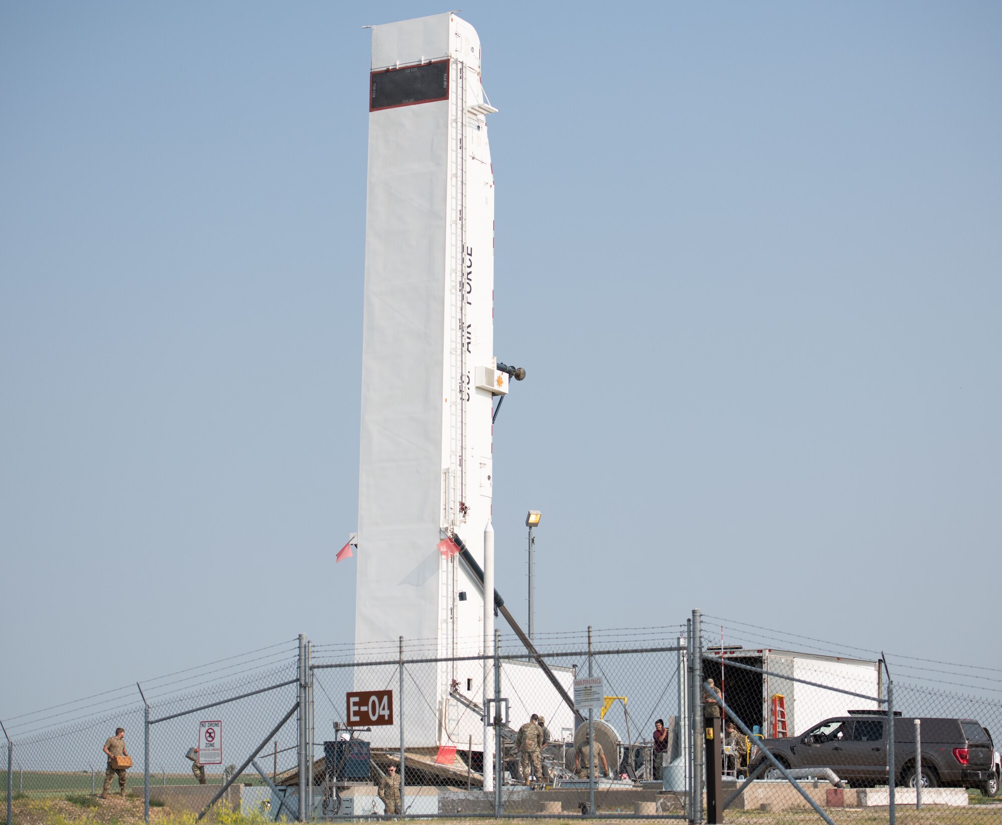 Airmen from the 91st Missile Maintenance Squadron raise a transport erector to its full height at Minot Air Force Base, North Dakota, July 10, 2023. The Airmen used the transport erector to lower an intercontinental ballistic missile III into a missile silo as part of Operation Bullystick. (U.S. Air Force photo by Airman 1st Class Trust Tate)