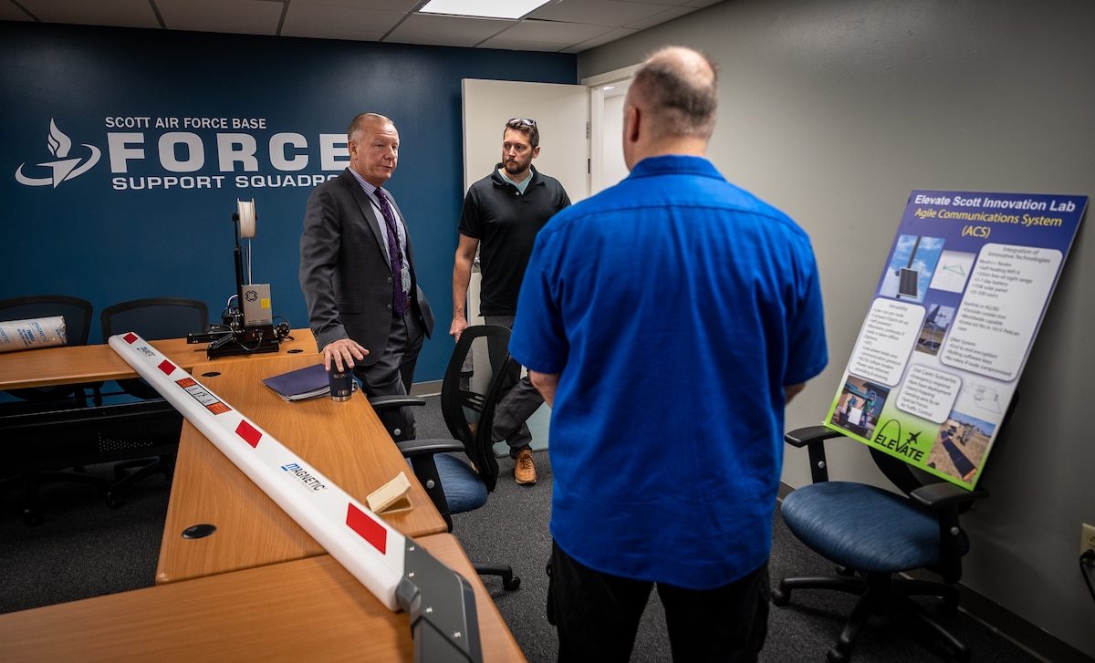 Brett Clark, Air Force Reserve Command Transformation and Innovation Office director of analysis, continuous improvement and innovation (CI2), speaks with Tech. Sgt. Brandon Barnes, Elevate chief maker, and with Ken Harris, 932nd AW Continuous Process Improvement chief June 28, 2023, Scott Air Force Base, Ill. Clark's visit to Elevate facilitated a dialogue on how AFRC can contribute to the broader innovation mission of the Air Force. (U.S. Air Force photo by Christopher Parr)