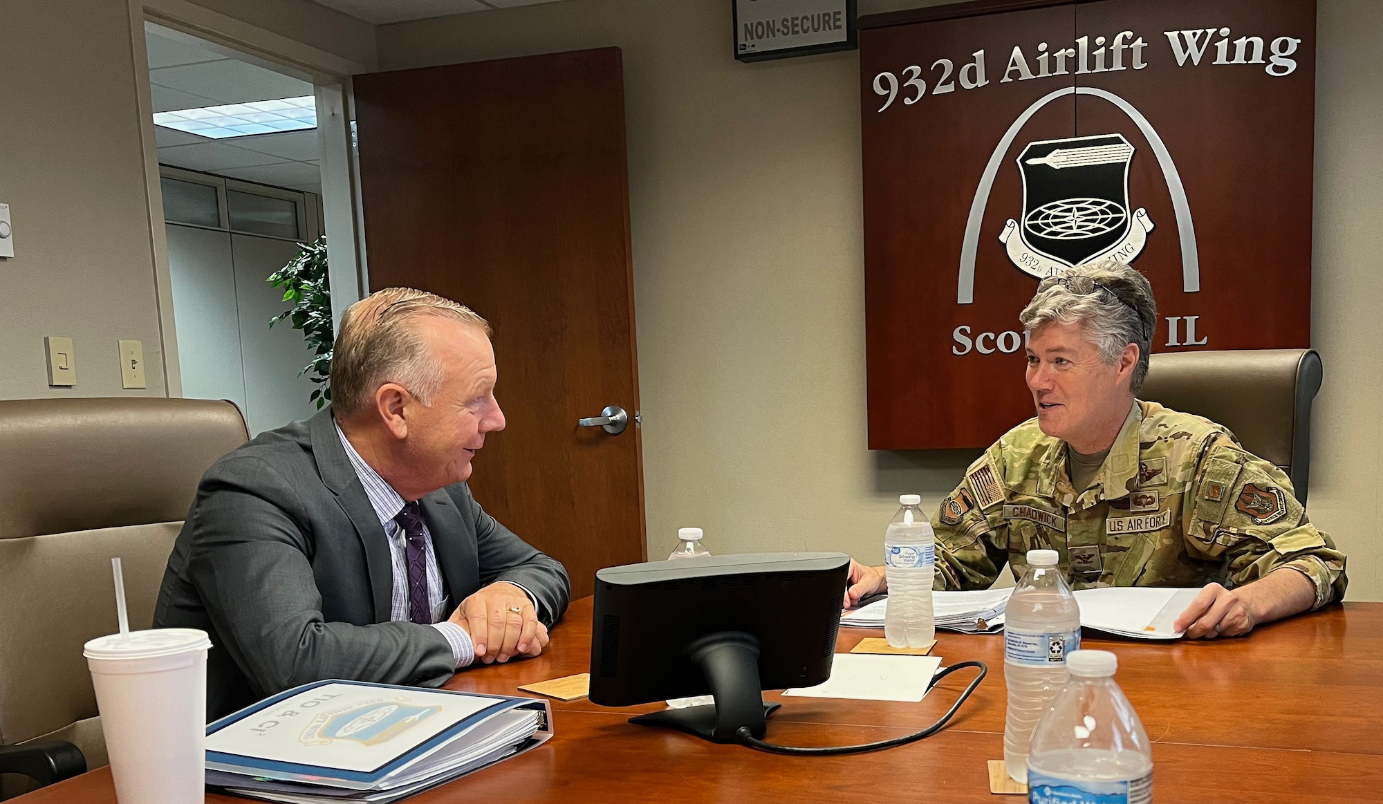 Col. Rick Chadwick, 932nd AW commander, discusses mission updates with Brett Clark, AFRC Transformation and Innovation Office director of analysis, continuous improvement and innovation (CI2), in the 932nd AW Headquarters Building, June 28, 2023, Scott Air Force Base, Ill. (U.S. Air Force Photo by Maj. Neil Samson)