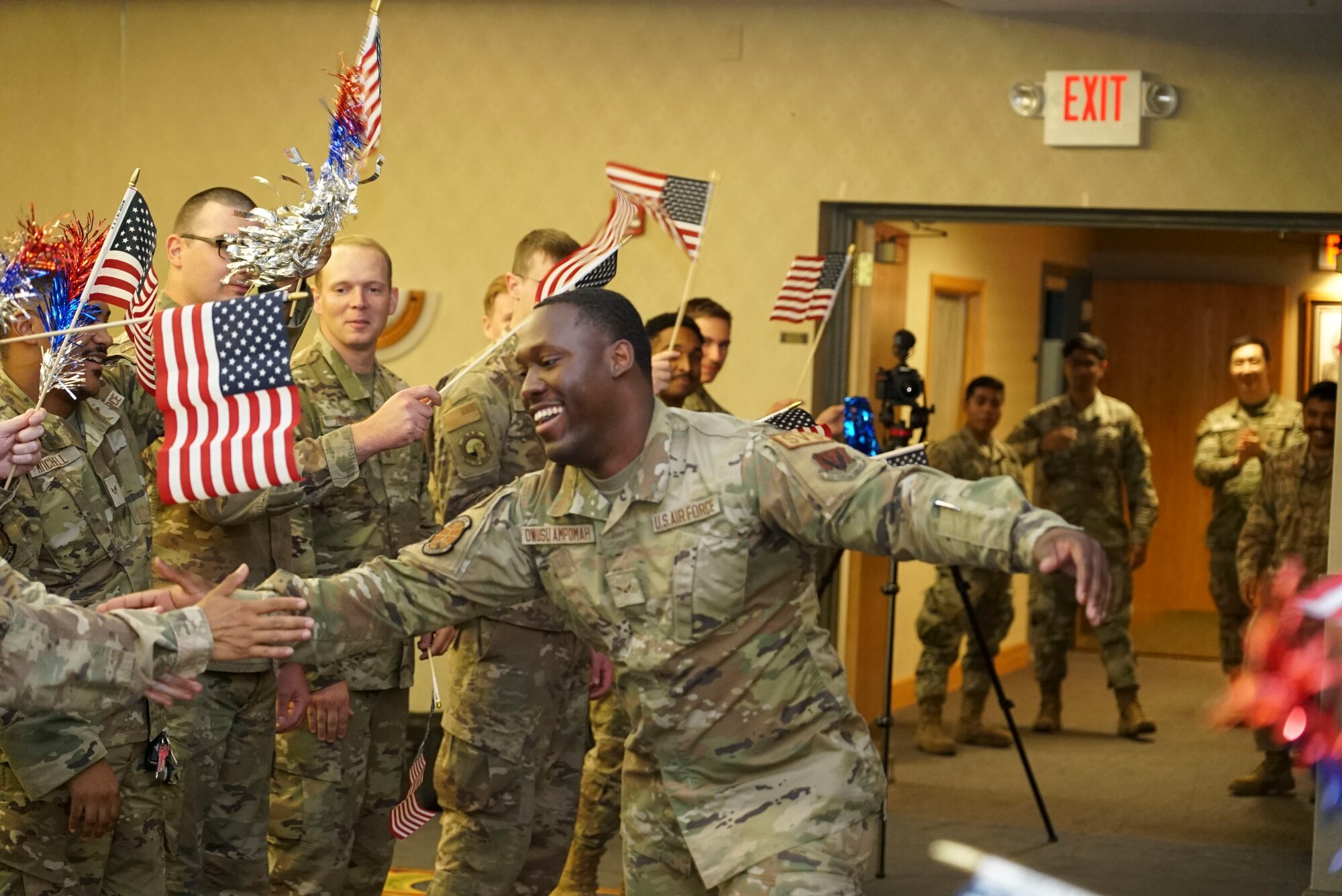 Airman runs to stage surrounded by fellow airmen