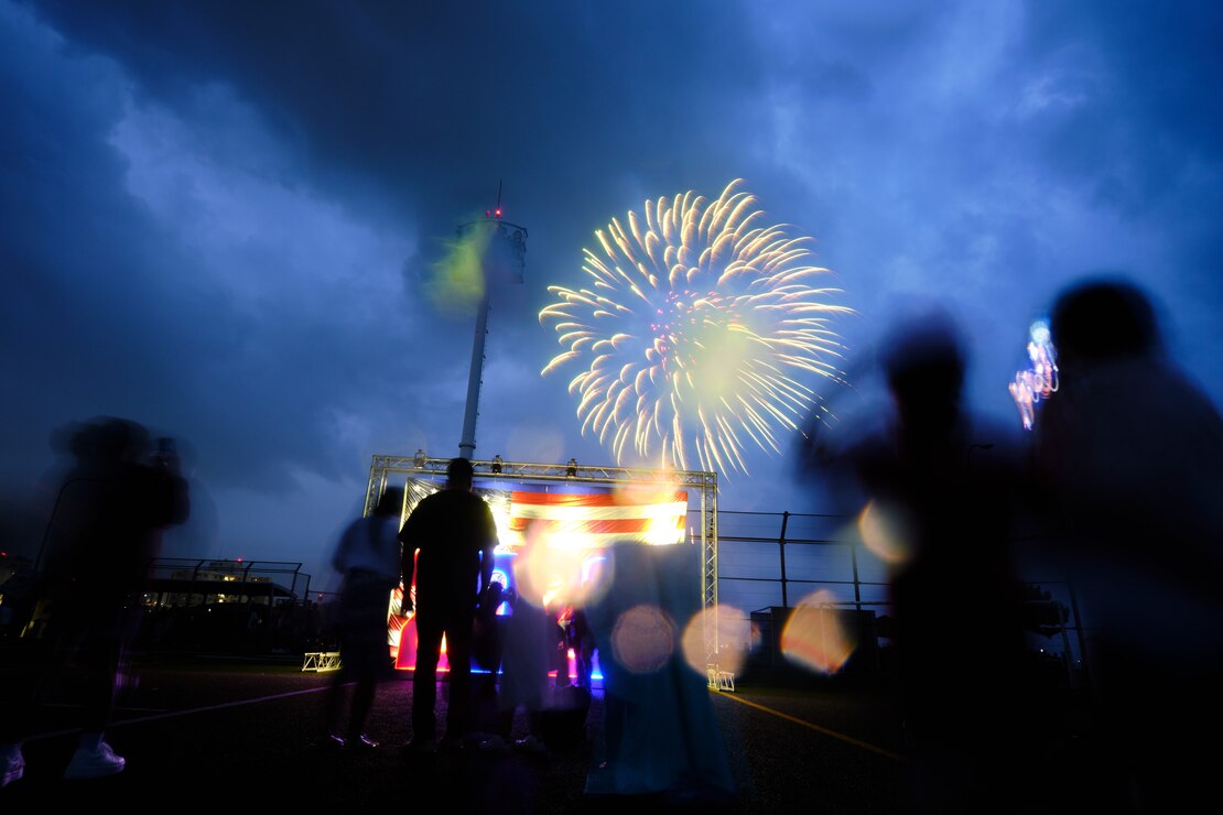 Commander, Fleet Activities Yokosuka community members watch the fireworks display over the base despite rainy weather July 4, 2023.