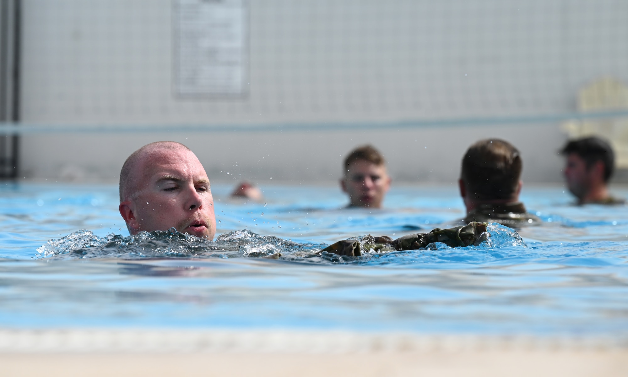 A photo of several people in a pool.