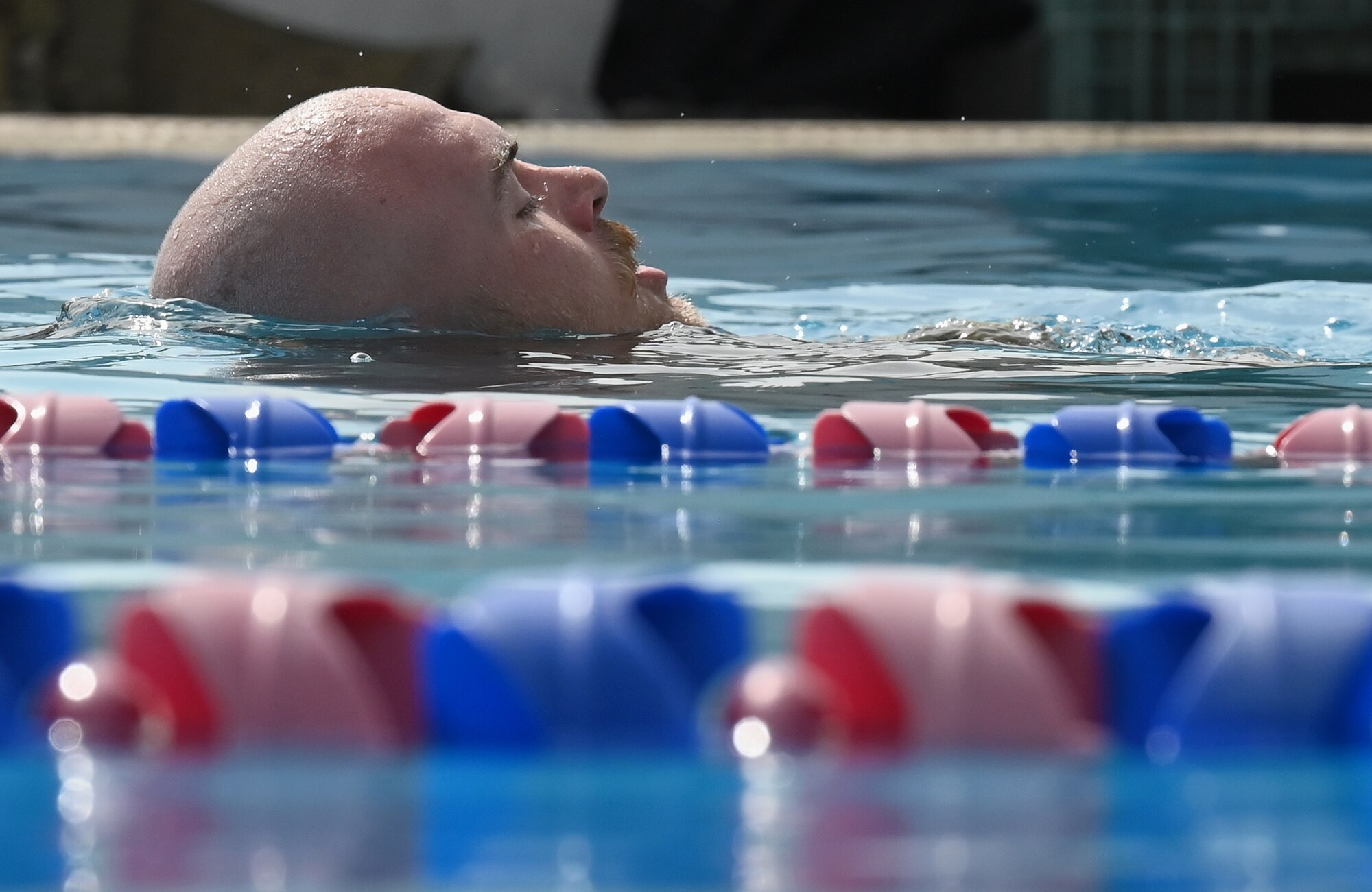 A photo a man swimming in a pool.