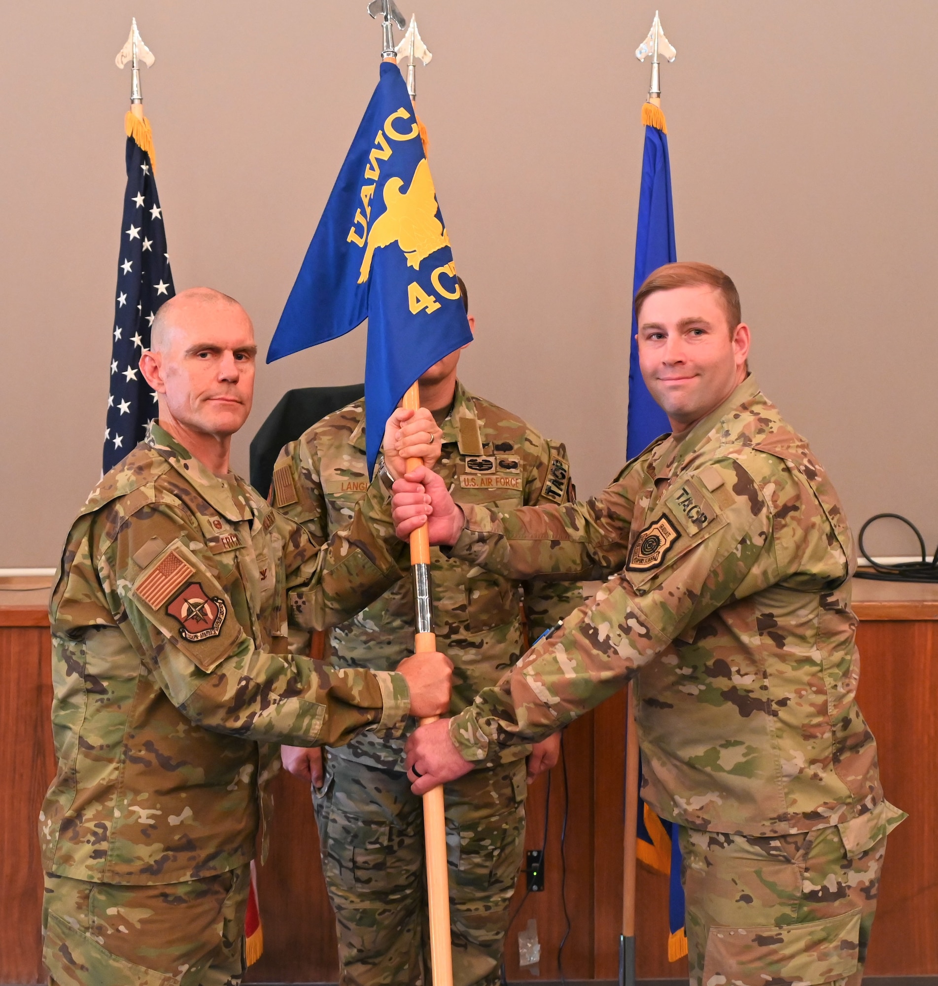U.S. Air Force Col. Dean Berck, left, United States Air Forces in Europe and Air Forces Africa Warfare Center Commander, presents the guidon to Lt. Col. Shawn Elliott, right, 4th Combat Training Squadron incoming commander, at Einsiedlerhof Military Complex, Germany, June 15, 2023.