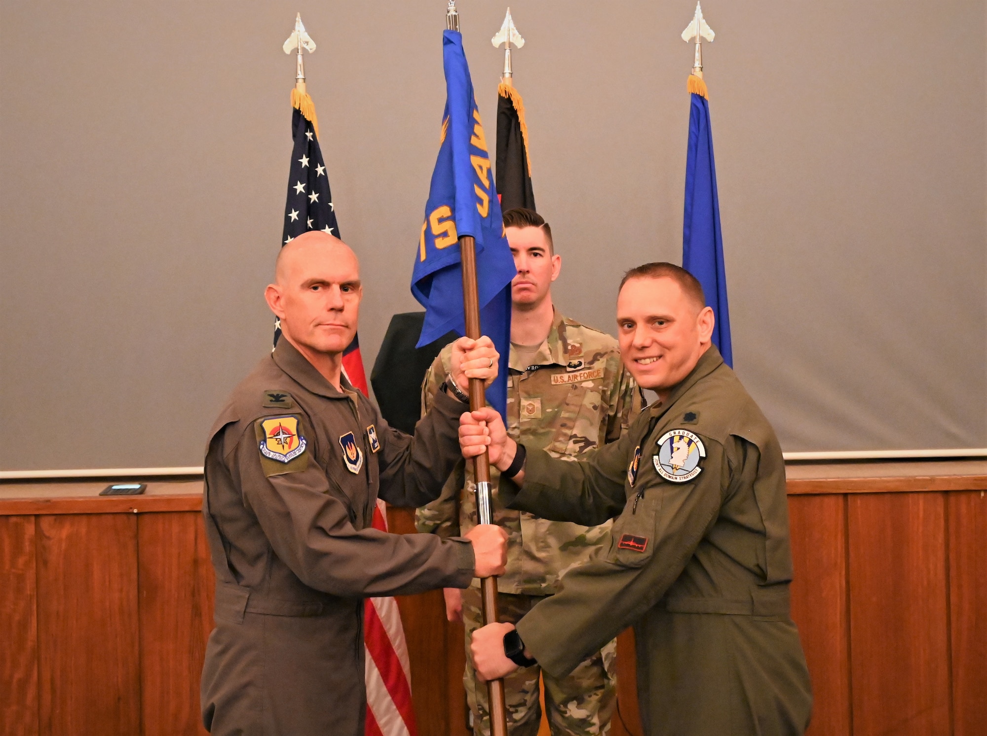 U.S. Air Force Col. Dean Berck, left, United States Air Forces in Europe and Air Forces Africa Warfare Center Commander, presents the guidon to Lt. Col. Ryan O'Neil, right, 5th Combat Training Squadron outgoing commander, at Einsiedlerhof Military Complex, Germany, June 6, 2023.