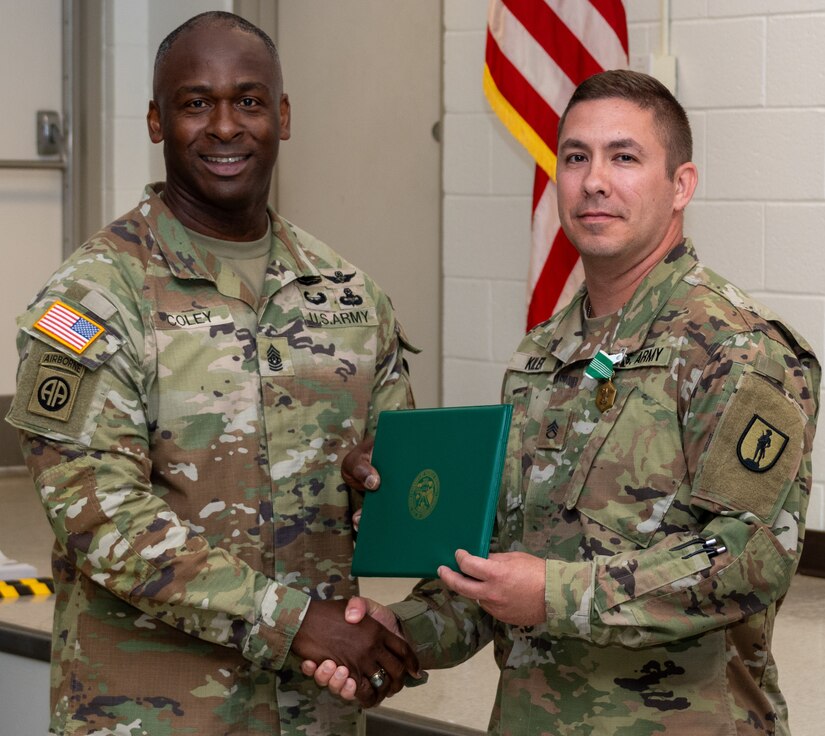 Command Sgt. Maj. Kirk R. Coley, left, U.S. Army Aviation Branch command sergeant major, present an Army Commendation Medal to Staff Sgt. Staff Sgt. Frank E. Kiler, from the Eastern Army National Guard Aviation Training Site Noncommissioned Officers Academy here, after being named the Noncommissioned Officer Academies Small Group Leader of the Year.