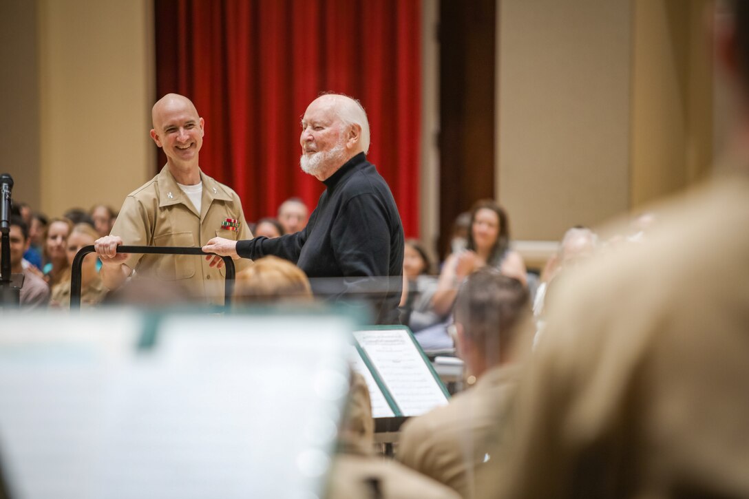 John Williams and Marine Band Director Col. Jason Fettig look at the Marine Band from behind the podium during rehearsal on July 15, 2023.
(U.S. Marine Corps photo by Gunnery Sgt. Brian Rust/Released)