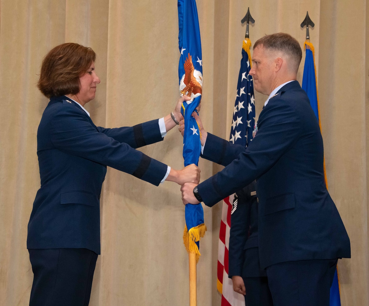 Lt. Gen. Andrea Tullos, Air University’s commander and president, passes the guidon to new Squadron Officer School commandant, Col. Kevin Lee during a change of command ceremony on Maxwell Air Force Base, Alabama, July 13, 2023.