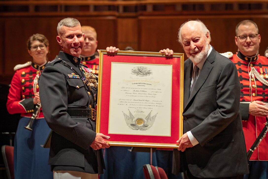 Assistant Commandant of the Marine Corps Gen. Eric M. Smith presents John Williams with a framed Honorary Marine Certificate.

Renowned Composer and Conductor John Williams was given the title of Honorary Marine on July 16, 2023. The presentation took place during the United States Marine Band's 225th anniversary concert at The Kennedy Center for the Performing Arts, which featured Williams conducting his music with the band.
Williams is best known for crafting the iconic scores to classic films including Star Wars, Harry Potter, Indiana Jones, and more. Over the past two decades, he has forged a strong bond with the Marine Band, sharing his extraordinary musical talents with the group time and again.
The title of Honorary Marine was conferred by former Commandant of the U.S. Marine Corps General David H. Berger, and was presented by Assistant Commandant of the Marine Corps General Eric M. Smith. 
(U.S. Marine Corps photo by Staff Sgt. Chase Baran/released)