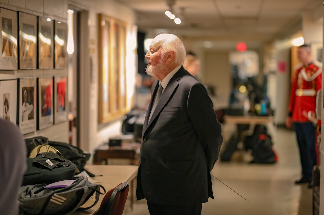 John Williams looks at a signed photo of himself hanging on the wall backstage at The Kennedy Center for the Performing Arts. Williams conducted "The President's Own" United States Marine Band for its 225th anniversary concert on July 16, 2023.

Williams conducted "The President's Own" United States Marine Band for its 225th anniversary concert at The Kennedy Center for the Performing Arts on July 16, 2023. Williams conducted selections from the films Star Wars, Indiana Jones, and Lincoln. This was the fifth time since 2003 that he has conducted the Marine Band in a public concert.
(U.S. Marine Corps photo by Gunnery Sgt. Brian Rust/released)