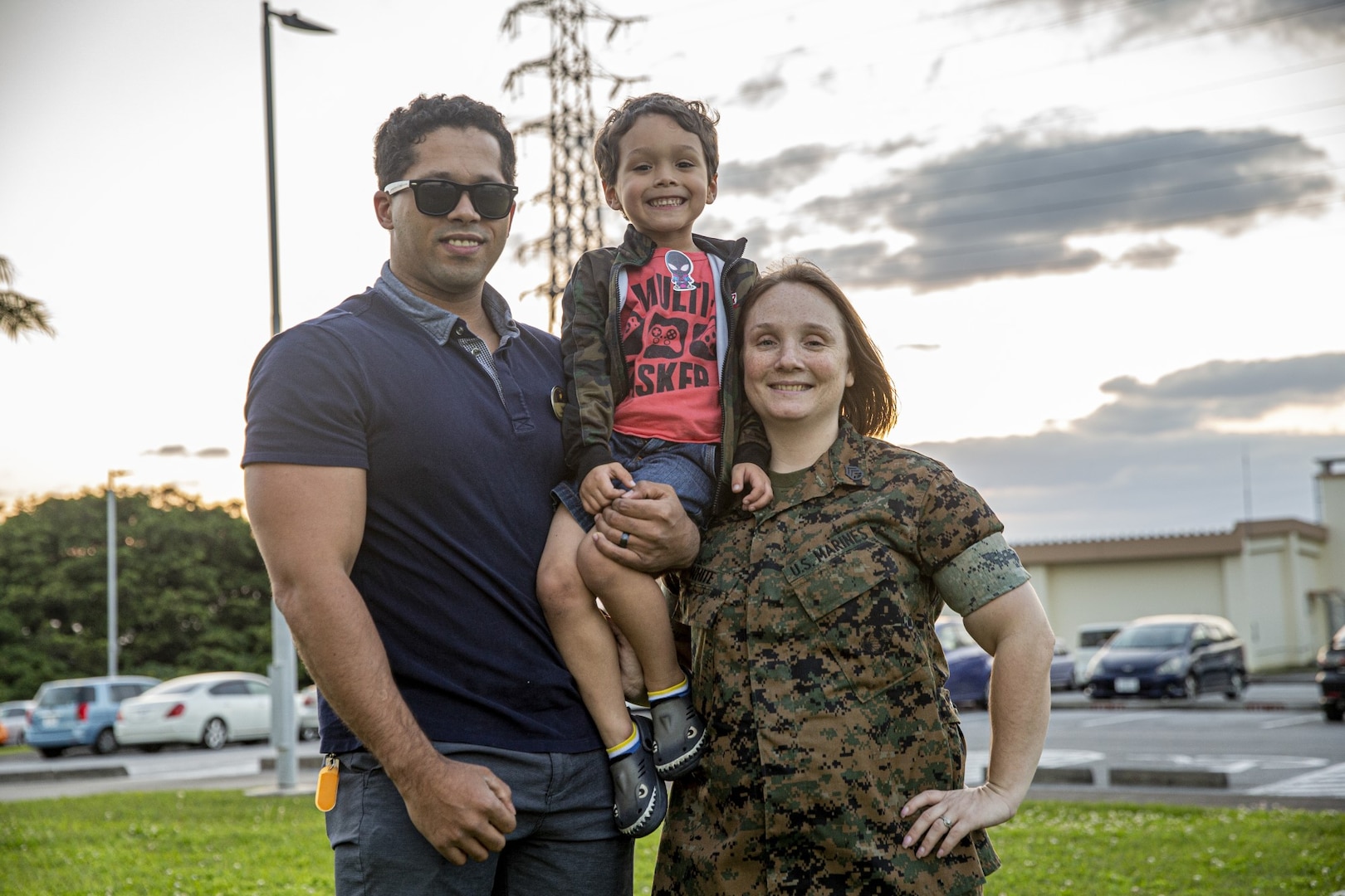 Service member poses with family