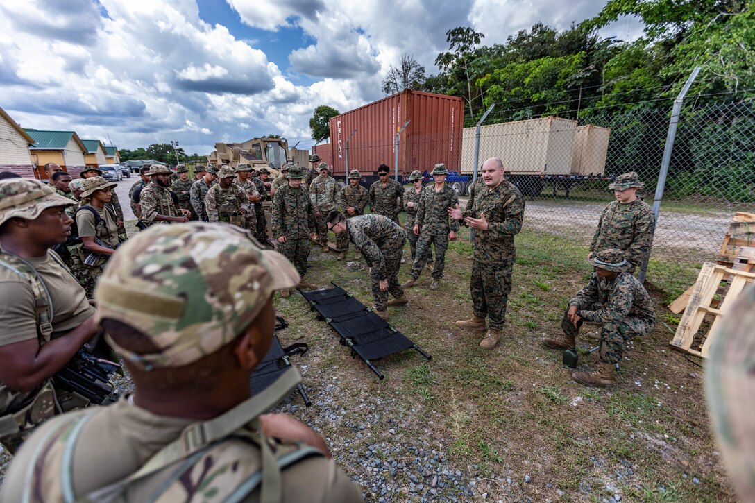 Royal Bermuda Regiment troops receive Tactical Combat Casualty Care training from a U.S. Sailor and several Marines during Tradewinds 2023 at Camp Seweyo, Guyana, July 16, 2023.