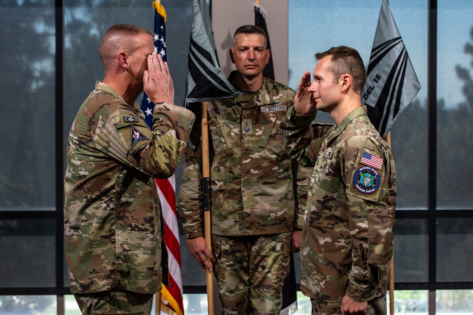 Two men in uniform salute eachother