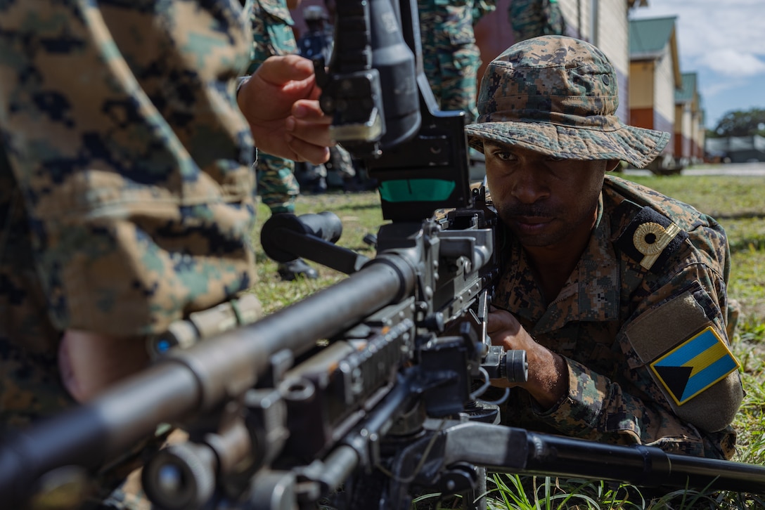 An officer in the Royal Bahamas Defence Force conducts an M240B weapon familiarization with U.S. Marines assigned to Fox Company, 2nd Battalion, 25th Marines instructs multinational forces during Tradewinds 23 at Camp Seweyo, Guyana on July 17, 2023.
