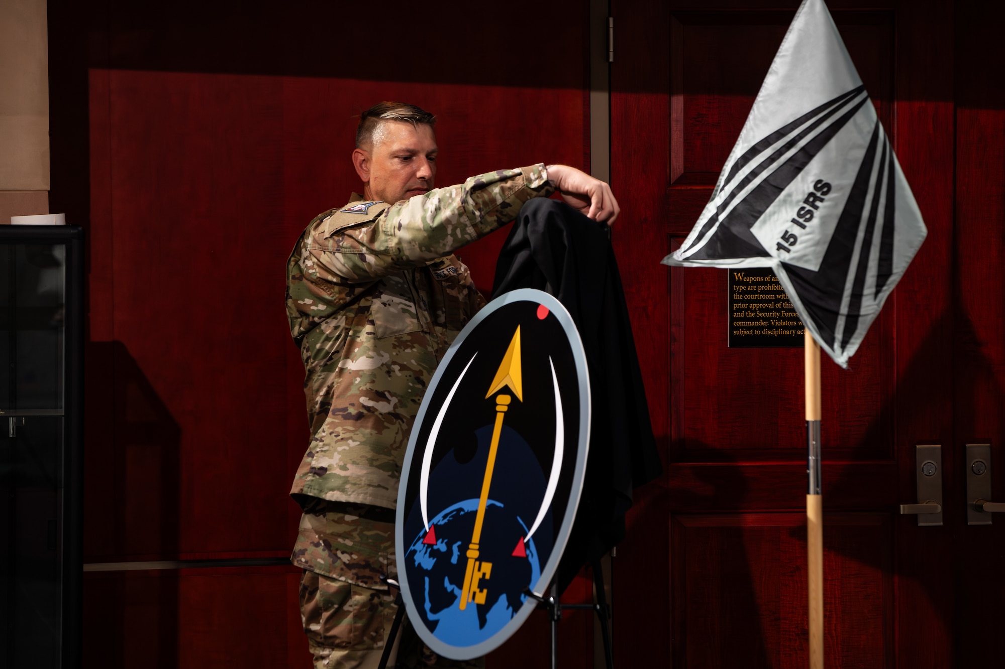 Man in uniform unveils logo