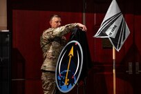 Man in uniform unveils logo