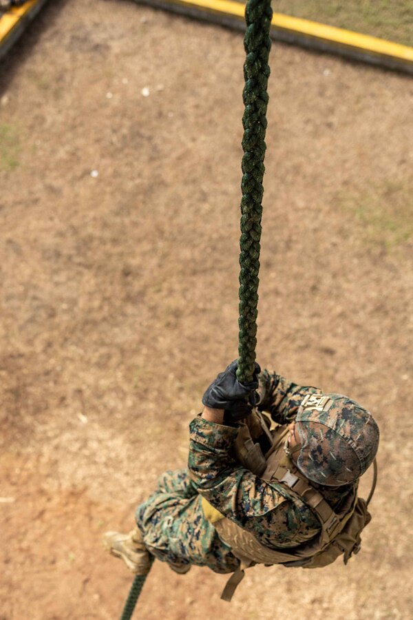 A U.S. Marine with 3rd Battalion, 23rd Marine Regiment, 4th Marine Division, fast ropes down a rappel tower during UNITAS LXIV on Base de entrenamiento de infanteria de marina (Colombian Marine Corps training base) Covenas, Colombia, July 17, 2023. UNITAS, taking place in Colombia this year, is the world’s longest-running annual multinational maritime exercise that focuses on enhancing interoperability among multiple nations and joint forces during littoral and amphibious operations in order to build on existing regional partnerships and create new enduring relationships that promote peace, stability, and prosperity in the U.S. Southern Command’s area of responsibility. (U.S. Marine Corps photo by Lance Cpl. Christian Salazar)