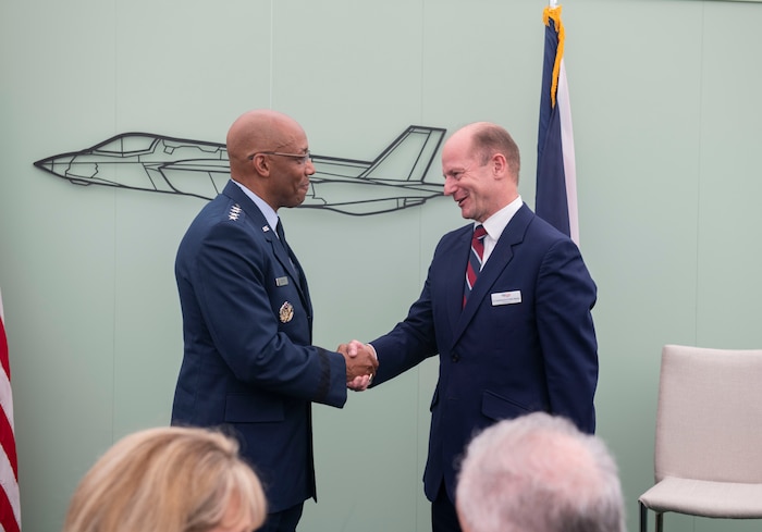 U.S. Air Force Chief of Staff Gen. CQ Brown, Jr., left, shakes hands with former Royal Air Force Chief of the Air Staff, Air Chief Marshal Sir Mike Wigston during the Royal International Air Tattoo at RAF Fairford, United Kingdom, July 15, 2023. Brown presented the Legion of Merit award to Wigston, which is presented for exceptionally meritorious conduct in the performance of outstanding services and achievements. (U.S. Air Force photo by Senior Airman Jason W. Cochran)