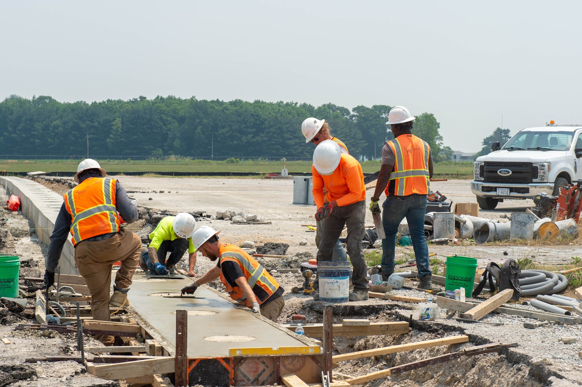 Construction workers install concrete at the end of the runway at Grissom Air Reserve Base, Ind. on June 9, 2023. Flying operations have temporarily moved to other locations while construction crews are hard at work resurfacing the entire length of the runway and updating the lighting systems. (U.S. Air Force Photo by Senior Airman Alexis Morris)