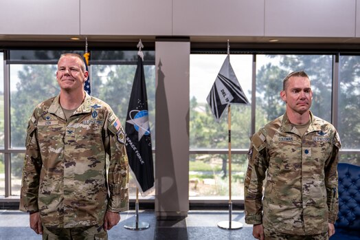 Two men in uniform stand at attention